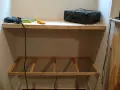DIY project: a drill, screws, and audio receiver are on a shelf, with a wooden frame below, ready for how to hang shelves.