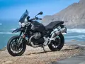 Moto Guzzi V85TT nera, pronta per esplorare, con la sua velocità massima che promette avventure sul mare.