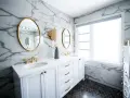 A modern bathroom vanity installation featuring white cabinets, marble walls, gold accents, and dual sinks.