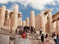 Tourists ascend the rocky path towards the Acropolis, a testament to how hard is the walk up to the Acropolis.
