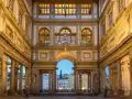 The Uffizi Gallery's courtyard at dusk, with its grand architecture and statues, offers a glimpse of Florence's artistic heritage, rivaling the Accademia.