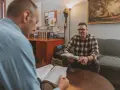 Two men discuss the Bible, exploring why God sent Jesus to save humanity.