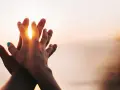 Two hands clasped at sunset, a symbol of purity and what is chastity: a deep, respectful connection.