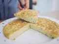 Una fetta di frittata, preparata con la ricetta perfetta, viene sollevata da un piatto decorato.