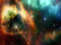Nebulosa cosmica con sfumature arancioni, verdi e blu. Un universo di stelle che ispira la ricerca e gli sbocchi lavorativi in astrofisica.