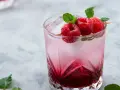 Orzeźwiający drink Wściekły Pies z malinami i miętą, idealny na letnie popołudnie.