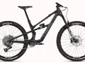 A black Canyon Spectral mountain bike, showcasing a mullet setup with a larger 29er front wheel and a smaller rear wheel, ready for any trail.