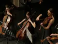 Orkiestra smyczkowa tworzy tło muzyczne filmu. Kobiety grają na wiolonczelach i skrzypcach, tworząc piękne dźwięki.