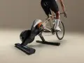 A cyclist rides indoors on a Wahoo Kickr Core 2 trainer, simulating an outdoor ride with realistic resistance.
