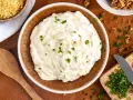 Cremiger Zwiebeldip, der an eine herzhafte Zwiebelsuppe erinnert, garniert mit frischen Schnittlauchstückchen.