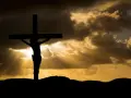 Silhouette of Jesus on the cross against a dramatic sky. His sacrifice shows Jesus died for our sins, offering hope.