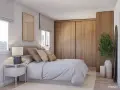 Acogedor dormitorio estilo escandinavo con cama, mesita de noche, armario de madera y planta decorativa.