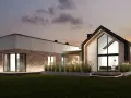 Nowoczesny dom z cegły i betonu z dużymi oknami, oświetlony wieczorem.