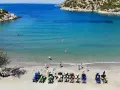 Linia pojazdów terenowych na plaży w Poros, Grecja, czeka na chętnych do zwiedzania. W tle turkusowe morze i skaliste wybrzeże.