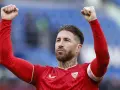 Sergio Ramos w czerwonej koszulce z podniesionymi pięściami, świętuje zwycięstwo. To właśnie tam, gdzie gra Sergio Ramos, czuć emocje!