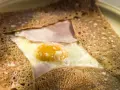 Crêpe bretonne garnie d'un œuf au plat, de jambon et de fromage. Un délice de crêpes françaises.