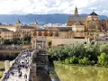 A bustling Roman bridge leads to the historic Mezquita-Cathedral of Córdoba. This view makes you wonder how many days in Córdoba are enough to explore its wonders.
