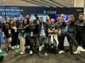 A lively group of Cribl customers and staff pose for a photo at a trade show, all smiles and team spirit.