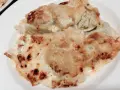 Ricos ravioles de Royan gratinados con queso dorado y burbujeante, listos para disfrutar.