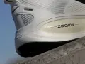 Biały but sportowy z technologią ZoomX. Drop w butach to różnica wysokości między piętą a palcami, kluczowa dla komfortu biegania.