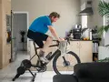 Man doing indoor cycling for beginners in his kitchen.