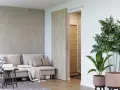 Jasne, oto opis:

Nowoczesny salon z szarą ścianą, beżową kanapą i stylowymi drzwiami przesuwnymi Porta. Obok stoi duża roślina w donicy.