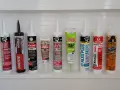 A variety of caulking tubes are lined up, ready for anyone wanting to learn how to caulk a shower. Brands include DAP, Loctite, GE, Mold Armor, Alex Plus, Red Devil, and Gorilla.