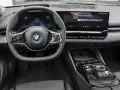 Wnętrze BMW 520d xDrive z nowoczesnym ekranem i kierownicą.