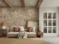 Sofá de madera con cojines y manta, junto a una pared con acabado rústico de piedra y vigas de madera.