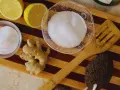 Ingredients for a homemade foot soak to remove dead skin: lemons, ginger, sugar, and a pumice stone.