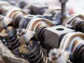 Close-up of engine valve train components, hinting at a camshaft sensor replacement.