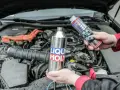 Dwie ręce trzymają preparaty Liqui Moly, sugerując jak wyczyścić katalizator domowym sposobem.