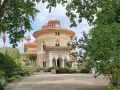The stunning Monserrate Palace in Portugal, a fairytale castle surrounded by lush greenery and exotic plants.