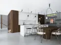 Nowoczesna kuchnia z wyspą, jadalnią i kotem przy schodach.