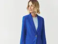 Kobieta w eleganckim, niebieskim żakiecie. Kolor kobaltowy a chabrowy idealnie podkreśla jej urodę.