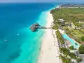 Rajskie plaże Zanzibar w lipcu: turkusowa woda, biały piasek, palmy i luksusowe bungalowy na wodzie. Idealne miejsce na wakacje.