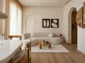 Un soggiorno in stile wabi sabi arredamento, con divano curvo, tavolino in legno grezzo, tappeto soffice e decorazioni organiche.