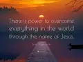 Sunset over a calm lake with a dock. Text reads: "There is power to overcome everything in the world through the name of Jesus.