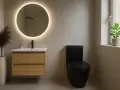 Salle de bain moderne avec un meuble vasque en bois, un miroir rond lumineux et un WC noir. La dimension wc est bien pensée pour un espace fonctionnel.