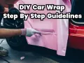 A person in gloves applies pink vinyl wrap to a car door, showing what you need to wrap your car with DIY step-by-step guidelines.