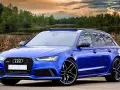 Niebieski **hatchback** z napędem quattro, zaparkowany nad jeziorem, z pięknym zachodem słońca w tle.