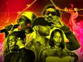 Des artistes de le rap, dont certains chantent au micro, sur fond de flammes et de graphiques.