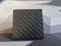 A small cube with a textured surface, showcasing the intricate pattern achieved through carbon fiber 3D printing.