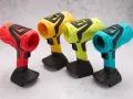 Spools of colorful 3D printing filament and containers of material on a wooden surface.