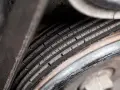 Cracked serpentine belt, a common cause of belt failure, shows signs of wear and tear.
