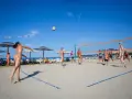 Gra w siatkówkę na plaży w Valalta naturist camp. Słońce, piasek i sportowa rywalizacja w wolności.
