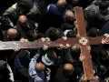 Wielki Piątek. Grupa mężczyzn niesie drewniany krzyż, upamiętniając drogę krzyżową.