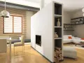 Moderne idee divisori in cartongesso: un camino integrato e libreria a giorno separano zona pranzo e soggiorno.