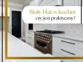 Nowoczesna kuchnia z białym blatem, który jest praktyczny mimo pozorów. Widoczna kuchenka i czarne drzwi.