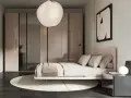 Camera da letto in una casa moderna, con letto rosa, armadio a specchio e lampada a sospensione.